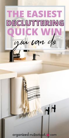 a bathroom sink sitting under a mirror next to a counter top with towels hanging on it