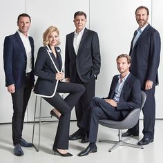 a group of business people posing for a photo