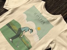 a white shirt with an image of a man playing golf