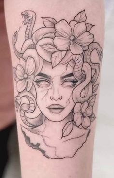 a woman's face with flowers and snakes on her arm