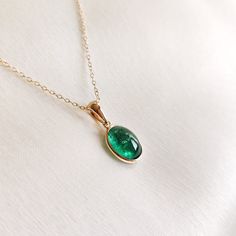 This stunning pendant is set in 14k Solid Yellow Gold with Natural Emerald with utmost precision. It is an unique gemstone pendant for nearly every occasion and is completely hassle-free jewelry. ITEM DETAILS: * Gem: Emerald * Gem Size: 7.5x10mm * Gem Shape: Oval * Gem Weight: 2.67 carats * Gold Purity: 14KT * Gold Weight: 0.51 gram * Total Weight of the Pendant: 1.04 gram The Gold purity is guaranteed and it comes with authentic 14KT gold hallmark. Since my items are handmade, they are absolutely nickel and lead free. CUSTOMIZATION: * Gemstone customization is available and it can be substituted with a gem of your choice. Kindly message me for the same. PACKAGING * The Pendant comes with layers of safe and secure wrapping along with Free handmade jewelry box with every purchase. ➡️Head to Timeless Emerald Necklace Gift, 14k Gold Gemstones With Bezel Setting For Gift, Fine Jewelry Cabochon Necklaces For Anniversary, Luxury Emerald Birthstone Necklace For Gift, Timeless Emerald Pendant Necklace Gift, Elegant 14k Gold Emerald Necklace Gift, Classic May Birthstone Gemstones For Gift, Anniversary Fine Jewelry Necklace With Cabochon, Anniversary Fine Jewelry Cabochon Necklace