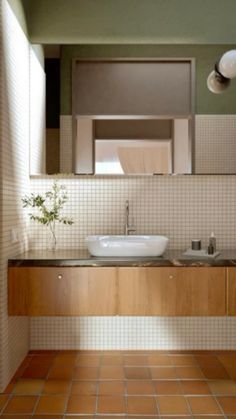 a bathroom with two sinks and a mirror on the wall next to tiled flooring