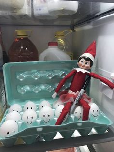 an elf is in the refrigerator with eggs