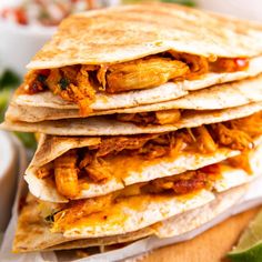 a stack of quesadillas sitting on top of a cutting board