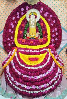 a statue made out of flowers in the shape of a buddha