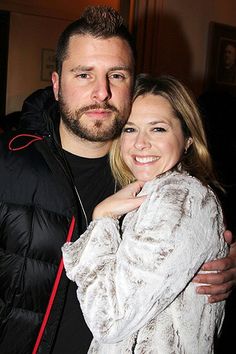 a man standing next to a woman who is hugging her