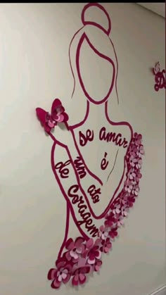 the wall is decorated with pink flowers and paper cut outs that say, be an angel