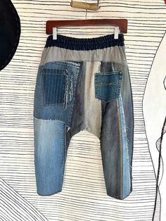 Multicolor Denim Pants With Pockets, Baggy Cotton Patchwork Jeans, Baggy Patchwork Cotton Jeans, Blue Deconstructed Cotton Jeans, Denim Blue Cotton Patchwork Bottoms, Denim Blue Cotton Bottoms With Patchwork, Baggy Denim Patchwork Pants, Baggy Patchwork Tapered Leg Pants, Baggy Denim Blue Patchwork Bottoms