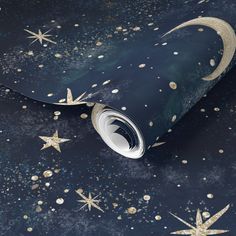 the stars and moon wallpaper is in blue with gold glitters on it's surface