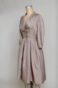 "1950s Modern Silk Camel Brown Anjac Fashions California Button Down Shirt Dress Camel brown silk, this dress has a beautiful modern cut. Gathered waistline, with a batwing cut. Anjac of California. Measurements shoulders: free chest: 39\" waist: 27\" length: 42.5\"" Silk Button-up Evening Dress, Button-up Silk Evening Dress, Formal Silk Button-up Dress, Formal Button-up Silk Dress, Elegant A-line Vintage Dress With Buttons, Elegant A-line Vintage Dress For Daywear, Classic Silk Dresses With Buttons, Elegant V-neck Vintage Dress For Daywear, Elegant Vintage Dress With V-neck For Daywear