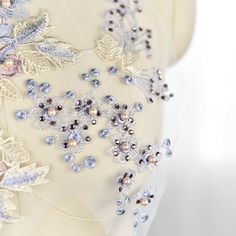 the back of a dress with beading on it