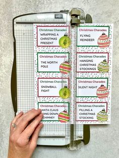 a hand holding a clipboard with christmas calendars on it and an apple in the middle