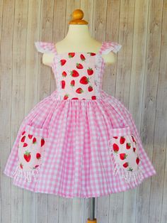 This beautiful dress is perfect for a birthday Strawberry theme party or any occasion. This dress is made with 1 skirt layer. Girls size Chest 2T 19'' 3T 21'' 4T 22'' 5T 23'' 6 24'' I use an underskirt just to show how puffy is the dress. if you want a puffy look you will need to buy a under skirt and it sold separately. Please leave me a note with the following instructions. *Size Strawberry Theme Dresses, The Strawberry Dress, Ichigo Outfit, Strawberry Theme Party, Strawberry Shortcake Dress For Baby, Strawberry Dress For Kids, Strawberry Shortcake Dress, Strawberry Clothes, Sweet Pink Strawberry Print Dress