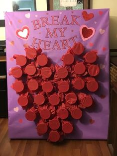 a heart made out of cupcakes on a bulletin board