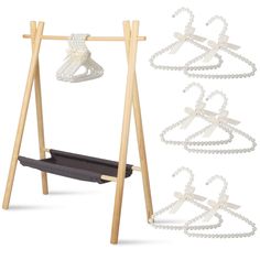 a wooden stand with two necklaces hanging from it