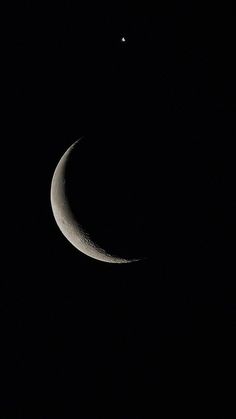 the crescent moon is seen in the dark sky