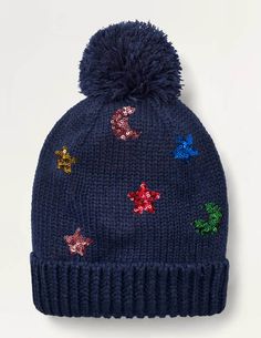 a blue hat with stars on it and a pom - pom at the top