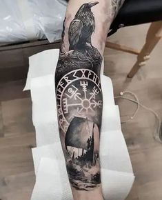 a man's arm with a clock and raven on it, in black and white