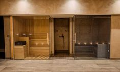 the inside of a sauna with lights on and two benches in front of it