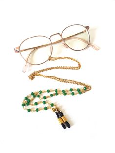 Gold colored glasses necklace with green beads. The necklace is universal. The connector with which you attach the necklace to the glasses is adjustable. You can use the necklace for normal glasses or sunglasses. The necklace comes without glasses. Length 88cm 34,65 inch Material Chain: stainless steel Necklace with the green beads: 14k gold plated Connector: silicone  Care of jewelry  It is actually simple, take good care of your jewelry and you will enjoy it for longer. Tips for the care of je Beads Glasses, Glasses Cord, Glasses Necklace, Sunglasses Cord, Sunglasses Necklace, Green Glasses, Glasses Chains, Colored Glasses, Gold Glasses