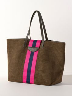 Give your accessories a sleek update with Shiraleah's Blakely Tote. This spacious and practical handbag is a perfect accessory for your everyday outfits and activities. The chic, olive-toned suede fabric is neutral enough to match any outfit, while the stylish pink and navy racing stripe adds a pop of feminine color. Pair with the matching Blakely Wristlet or other items from Shiraleah to complete your look! Shiraleah is a trend-driven lifestyle brand focused on the little gifts that make life s Spa Wraps, Accessories Display, Racing Stripes, Suede Fabric, Cool Backpacks, Framed Gifts, Zip Pouch, Pouch Bag, Scarf Hairstyles