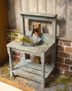 an old wooden sink in front of a brick wall with moss growing on the floor