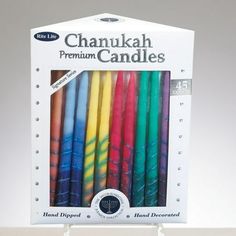 an assortment of colorful candles in a box