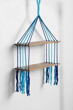 a hanging shelf with two shelves on it and some blue beads attached to the top