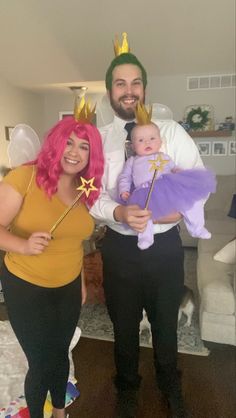 the man and woman are dressed up as princesses for their baby's first birthday