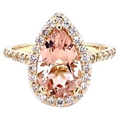 3.04 Carat Morganite Diamond 14K Yellow Gold Engagement Ring This stunning ring has a Pear Cut Morganite as its center that weighs 2.47 Carats. The Morganite is surrounded by a Halo of 39 Round Cut Diamonds that weigh 0.57 Carats. (Clarity: SI2, Color: F). The total carat weight of the ring is 3.04 Carats. The ring is made in 14K Yellow Gold and weighs approximately 3.3 grams. The ring size is a 7 and can be resized at no additional charge. Contemporary Engagement Rings, Cute Engagement Rings, Yellow Gold Engagement Ring, Morganite Diamond, Yellow Gold Engagement, Gold Engagement Ring, Gold Engagement, Pear Cut, Round Cut Diamond