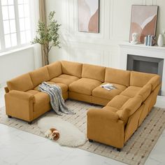 a living room with a sectional couch and rug on the floor next to a fireplace