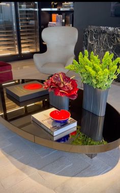 a coffee table with flowers and books on it