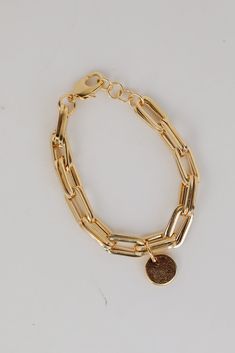 Pledge your love for the Ashton Gold Chain Bracelet! This cute bracelet is made of a gold chainlink with a circle charm. Wear it on its own or stacked with other bracelets to instantly upgrade your look! Gold Plated Chainlink Circle Charm Lobster Clasp One Size | Diameter 2.5" Sneaker Heels Wedges, Cute Bracelet, Casual Kimono, Gold Chain Bracelet, Jewelry Bracelets Gold, Upgrade Your Look, 4th Of July Outfits, Rust Dress, Gold Bracelet Chain