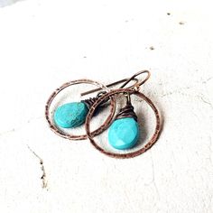 "Two genuine faceted turquoise semi precious teardrop shaped stones are dangled inside a hand hammered copper circle. They measure 1 1/4\" from the top of the copper earwire and measure 3/4\" wide. Very Lightweight and comfortable for all day wear. All my jewelry comes in a box with a decorative ribbon ready for gift giving whether it is a gift for you or someone special. See more of my jewelry designs here: https://www.etsy.com/shop/JensBeadBox Thank you for visiting Jen's Bead Box Jewelry!" Turquoise Wire Wrapped Dangle Hoop Earrings, Turquoise Wire Wrapped Round Jewelry, Turquoise Dangle Hoop Earrings Wire Wrapped, Turquoise Teardrop Wire Wrapped Jewelry, Turquoise Wire Wrapped Hoop Earrings Gift, Turquoise Copper Dangle Jewelry, Hypoallergenic Turquoise Dangle Jewelry, Turquoise Hoop Jewelry Wire Wrapped, Turquoise Natural Stone Hoop Earrings As Gift