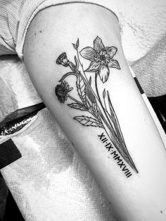 a black and white photo of flowers on the arm