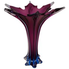 a purple glass vase sitting on top of a table