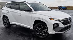 a white suv parked in a parking lot