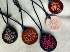 "Hand crafted leather necklace for women and men. Embossed Celtic leather talisman necklace in various styles and colors. Adjustable waxed cotton cord. The size of the pendant: 1 3/8\" (3.5cm) in diameter. Adult and child size. For more information please don't hesitate to contact me. For deliveries within the United Kingdom I use \"Royal Mail Standard 2nd Class\". Upgrade is available to \"Royal Mail Signed For\" if you prefer extra peace of mind. For deliveries to the rest of the world I use \ Waxed Cord Pendant Necklace Gift, Traditional Leather Jewelry As Gift, Traditional Leather Jewelry For Gifts, Leather Necklace With Adjustable Cord As Gift, Waxed Cord Round Pendant Necklace For Gift, Leather Necklace With Adjustable Cord For Gift, Triquetra Necklace, Braided Leather Necklace, Leather Patterns