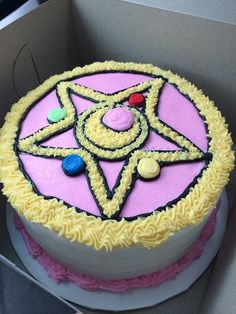 a pink and white cake with yellow icing on it's bottom is shown