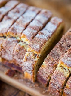 sliced loaf of banana bread sitting on top of a wooden cutting board