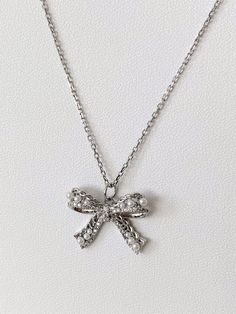 This necklace is made of a beautifully detailed ribbon pendant with tiny little pearls decors, on a delicate stainless steel chain (~1.5mm). The silver plated bow ribbon measures ~20x17mm; its filigree and vintage style is the highlight of the necklace, suitable for day-in and day out.  Materials: Ribbon charm:  Silver plated with faux tiny pearls Cable chain: Stainless steel 📿Necklace is 16 inch (40cm) in length and complimentary with an extender (~5cm) to adjust the length. 💌 A complimentary Silver Bow Necklace For Wedding, Delicate Silver Jewelry With Bow Detail, Delicate Silver Jewelry With Bow, White Jewelry With Decorative Bow For Wedding, Formal Silver Jewelry With Decorative Bow, Elegant White Ribbon Necklaces, White Decorative Bow Jewelry For Wedding, White Wedding Jewelry With Decorative Bow, Delicate Ribbon Necklace Gift