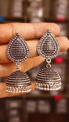 Listed as a must-have earring, jhumkis will always be a woman's favorite accessory! Our  Leaf Silver Oxidised Jhumkis are one to would opt for when you want the simple yet trendy look, pair these up with your straight kurtas or your soft mulmul sarees, these will leave you feeling pretty all day long! Traditional Oxidized Drop Earrings Jhumkas, Traditional Oxidized Jhumkas Drop Earrings, Traditional Oxidized Finish Jhumkas Drop Earrings, Silver Dual-tone Bohemian Jhumkas, Bohemian Silver Dual-tone Jhumkas, Silver Bohemian Dual-tone Jhumkas, Silver Jhumkas For Navratri, Traditional Silver Earrings With Tilla, Silver Dual-tone Jhumkas For Gift