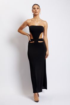 The MARISSA Strapless Maxi Dress With Waist Tie breaks free from the classic maxi with striking cut-outs that channel the fierce and feminine. She features a thigh-high split that is sure to turn heads and is crafted from a crepe fabrication that hugs your body in all the right places. Complete the look with a bold lip and statement earrings for a flawless finish. FEATURES: Strapless maxi dress Front and back cut outs Fitted to waist, loose from hip to hem Centre back zip fastening Lined FIT, FA Black Maxi Dress With Cut-out Waist For Evening, Fitted Maxi Dress With Cut-out Waist For Night Out, Fitted Maxi Dress With Side Cutouts, Black Fitted Maxi Dress With Cut-out Waist, Chic Maxi Dress With Side Slits And Cut-out Waist, Stretch Cutout Maxi Dress For Night Out, Black Strapless Dress With Cutout, Cut-out Waist Maxi Dress For Night Out, Cutout Waist Maxi Dress For Night Out