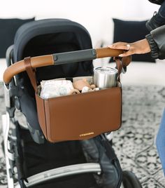 a baby stroller filled with items sitting on top of a carpet