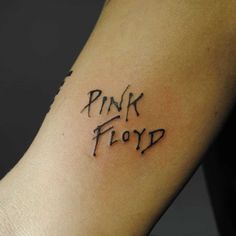 a tattoo with the word pink floyd written on it's left arm and writing in black ink