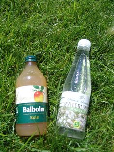 two bottled water bottles sitting in the grass