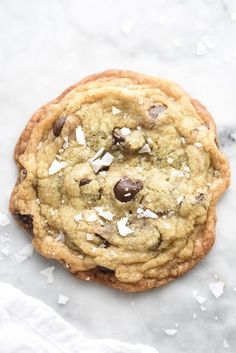 a chocolate chip cookie with coconut flakes on top