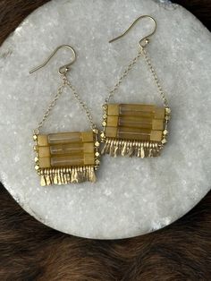 The "Carmine" earring is very gift-able and a classic accessory to add a little something special to the every day- that easily goes from day to night and looks with any hair color. They're light toward medium weighted and have great movement from hand-forged gold fringe.  Handcrafted Specifics: Stone: yellow fluroite tube beads and yellow jade cube beads Other materials: brass plated multi-faceted beads, gold chain with hand-forged gold fringe. Gold filled Ear wire/Fish hook  Weight/feel: mediu Wire Wrapped Citrine Dangle Earrings, Gold Citrine Dangle Earrings, Yellow Bohemian Rectangular Jewelry, Yellow Rectangular Bohemian Jewelry, Artisan Long Drop Gold Jewelry, Elegant Yellow Wire Wrapped Earrings, Yellow Wire Wrapped Drop Earrings, Gold Chain Dangle Brass Earrings, Yellow Brass Dangle Jewelry