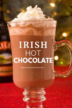 irish hot chocolate in a glass mug with whipped cream on top and the words, irish hot chocolate