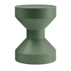 a green vase sitting on top of a white surface